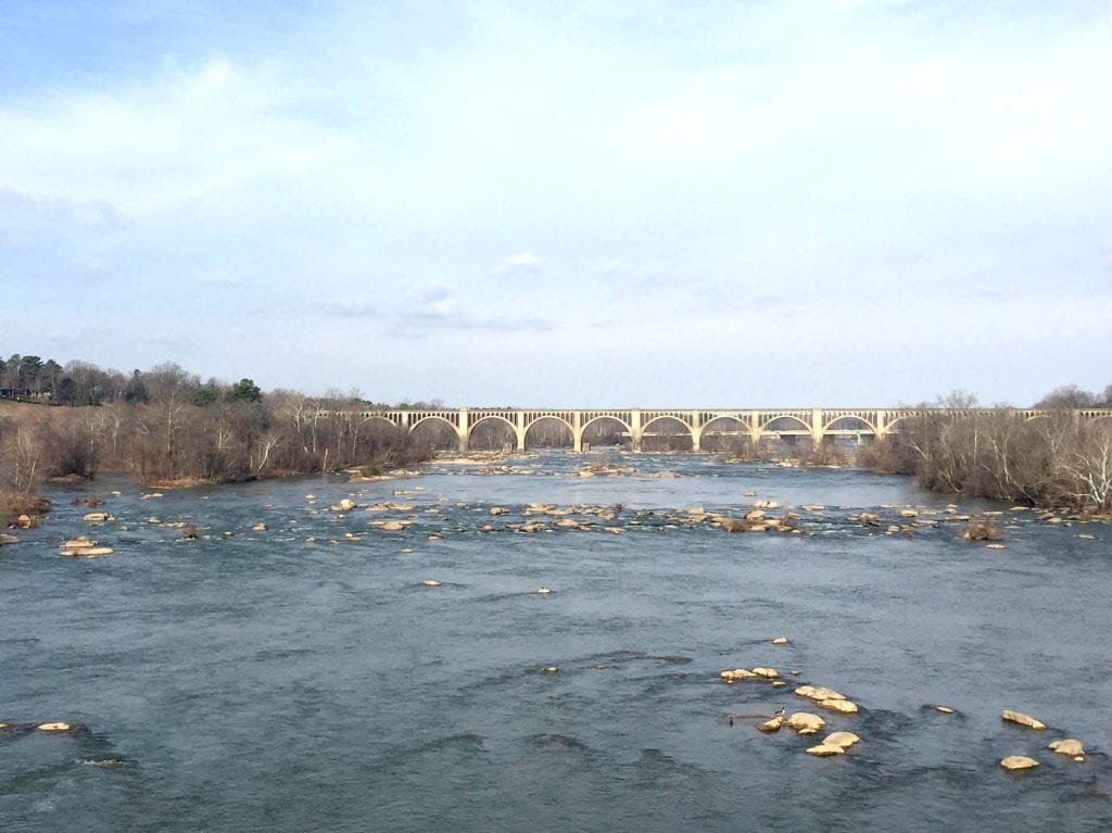 wide river with a bridge in the background